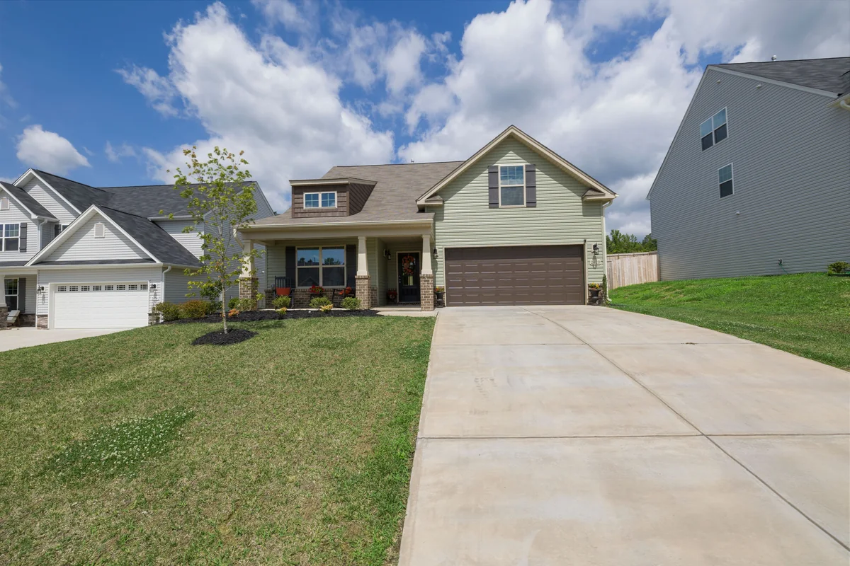 Contemporary suburban house with a driveway and attached garage.