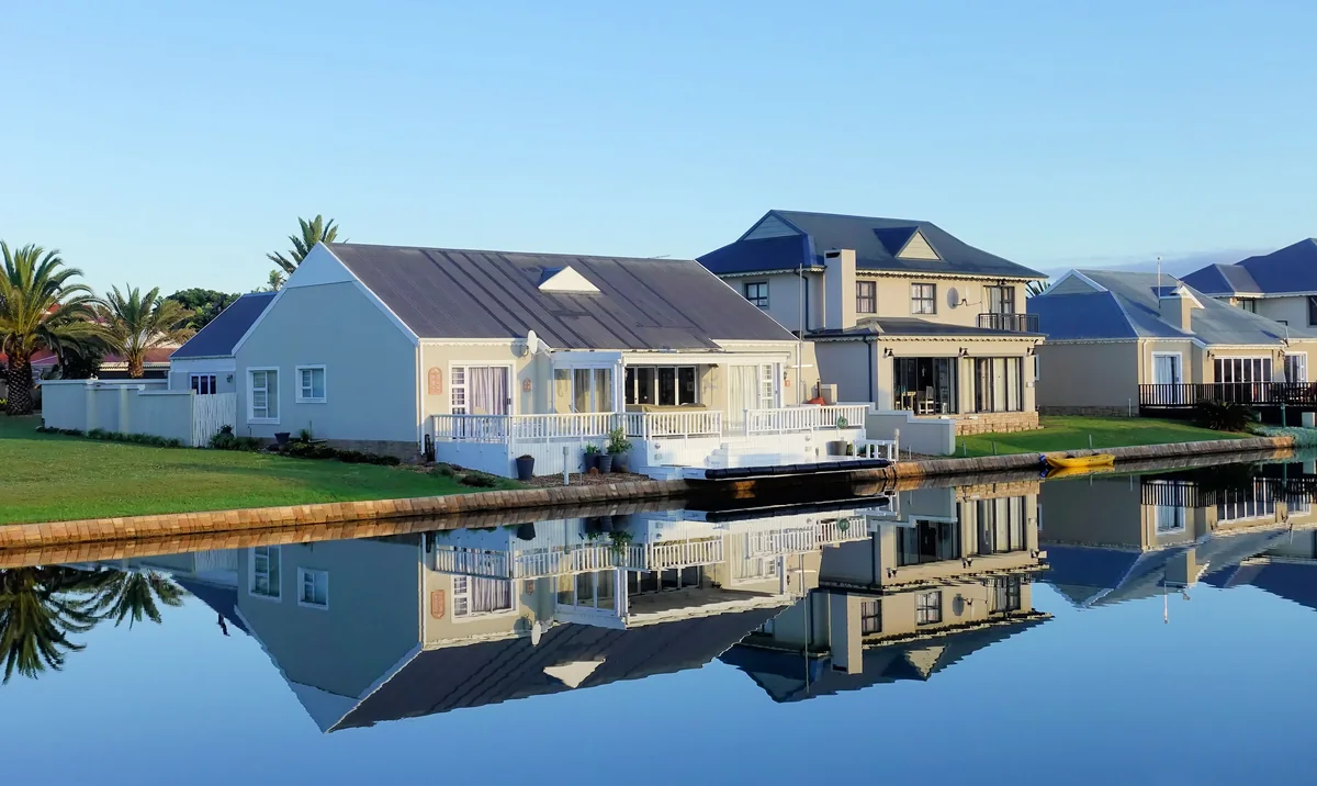 Homes beside a still pond with small docks along the water.